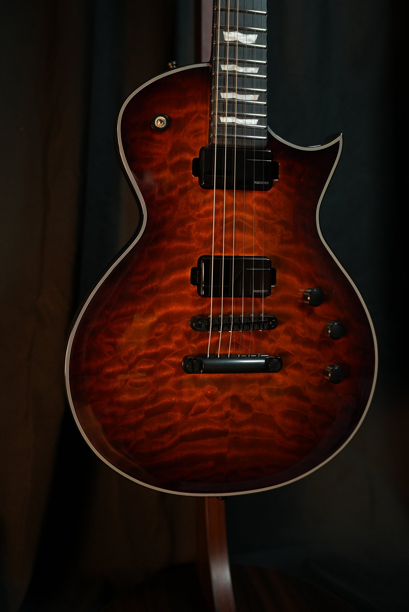 Close-up of ESP E-II Eclipse Tiger Eye Sunburst Fishman Fluence Modern Humbucker pickups and Gotoh bridge
