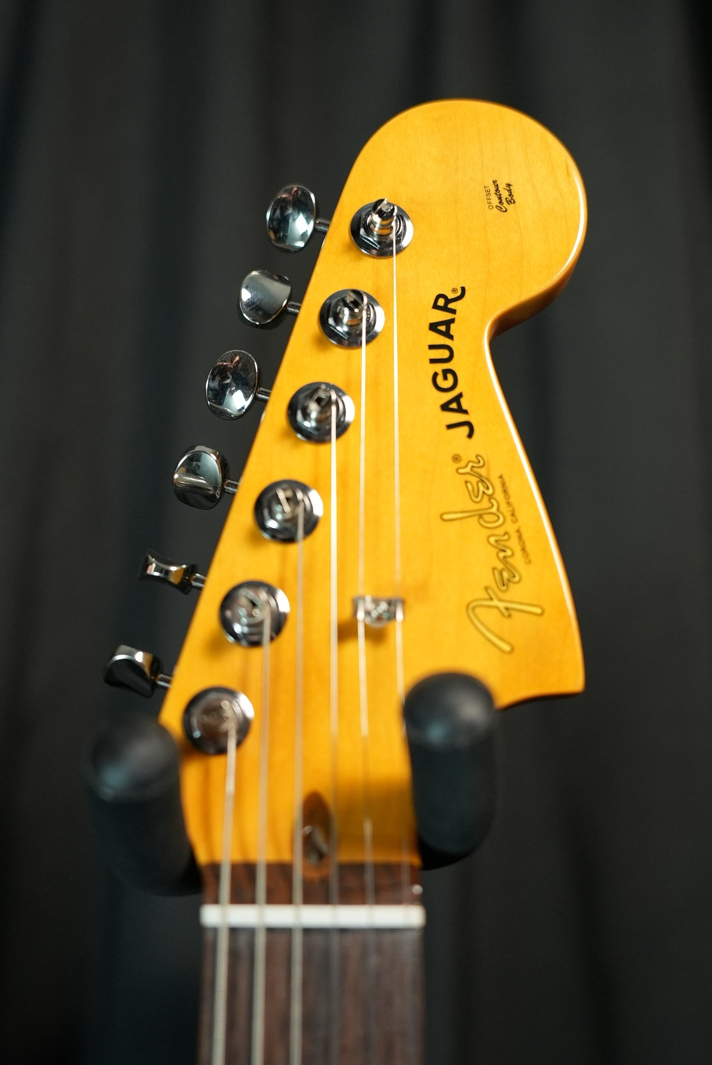 Close-up of headstock and maple neck on Fender American Professional Classic Jaguar 3-Color Sunburst electric guitar