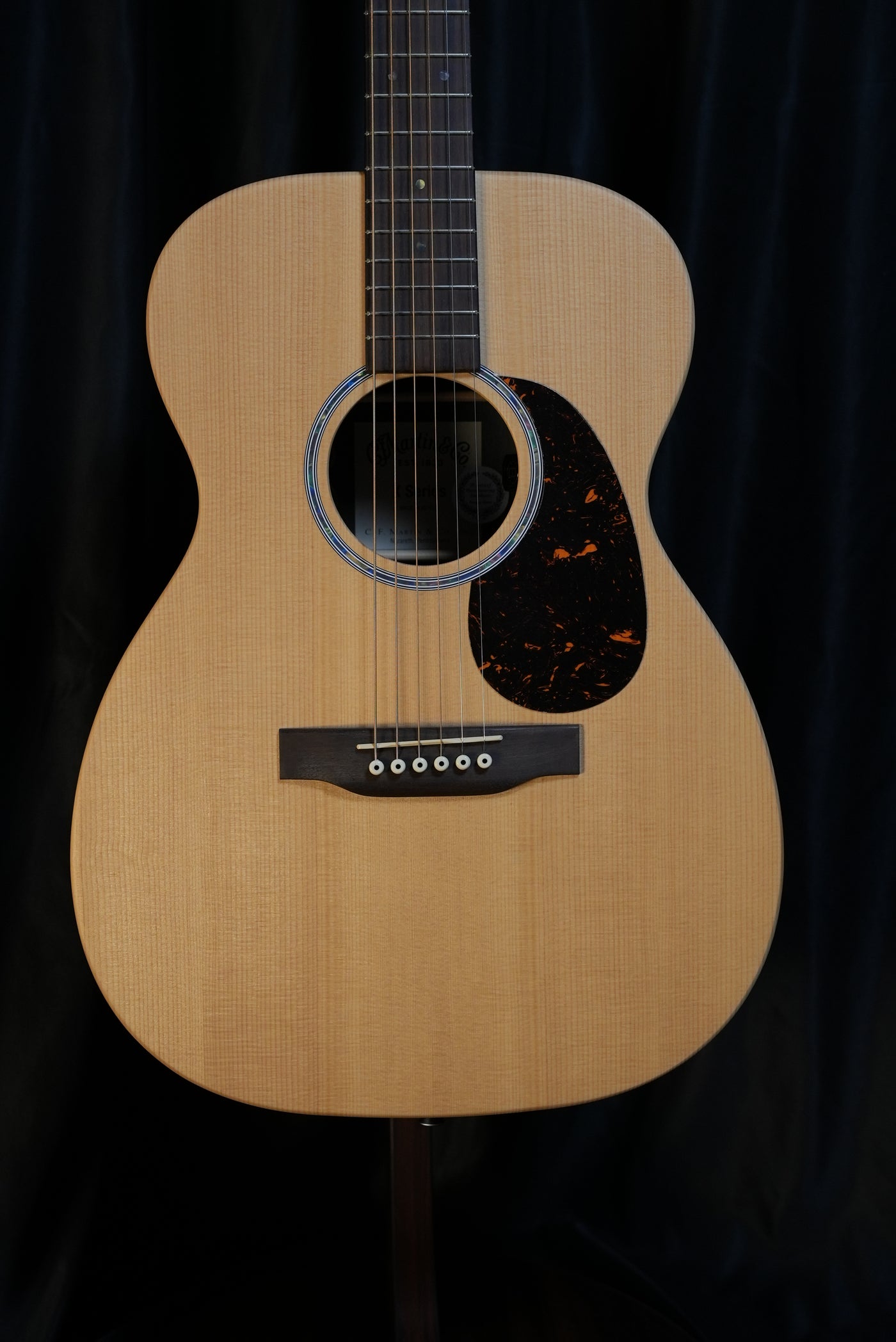 Martin 00-X2E acoustic-electric guitar full front view showing solid spruce top and Brazilian rosewood pattern HPL back and sides
