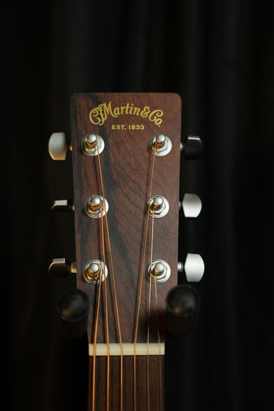 Close-up of Martin 00-X2E headstock with Martin decal logo and satin chrome closed-gear tuners