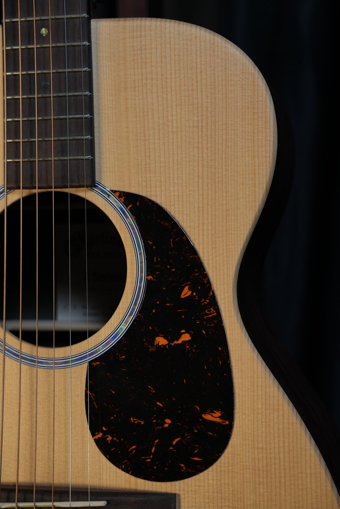 Side profile of Martin 00-X2E 00-size body, showing compact depth and HPL sides