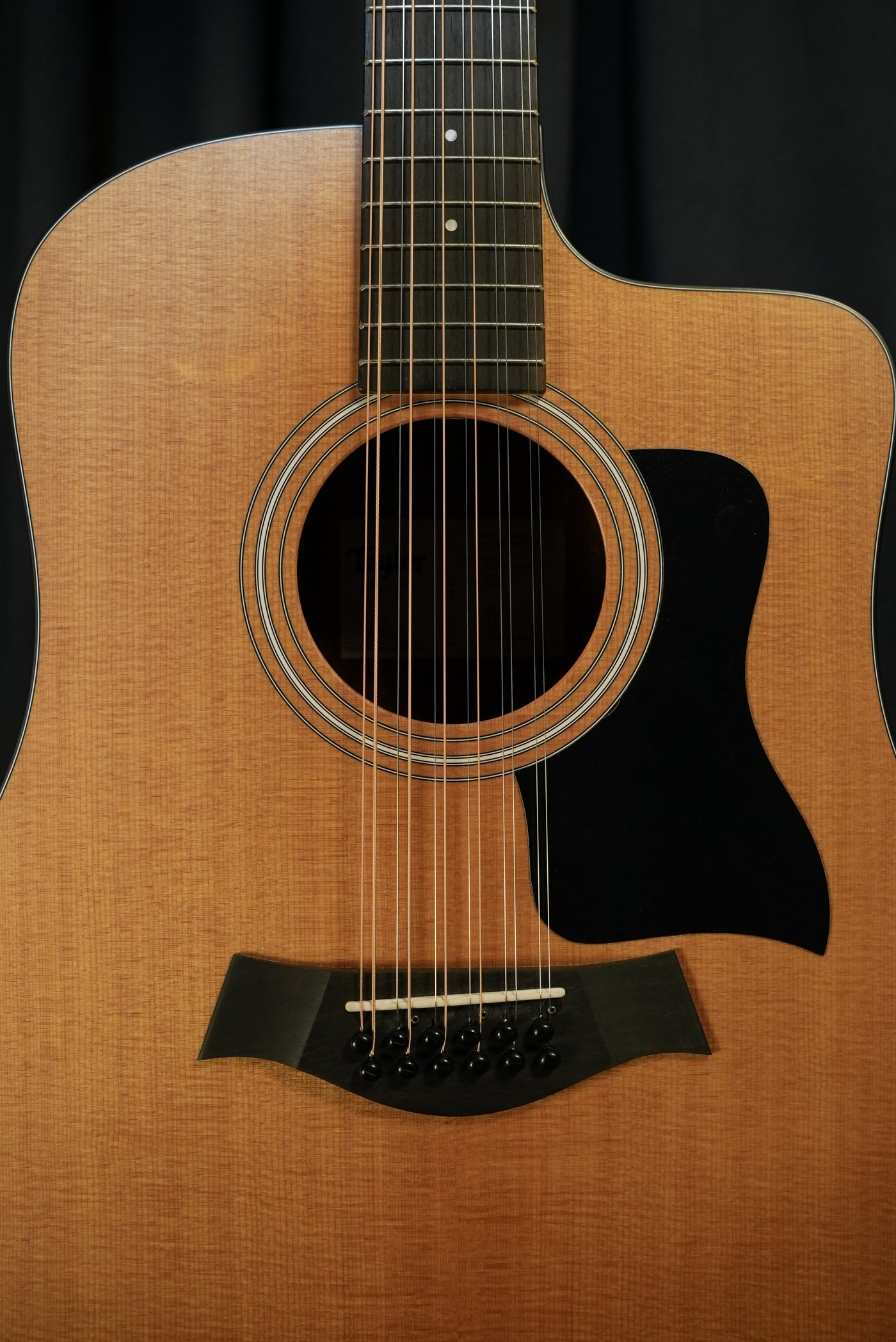 Close-up of the Taylor 150ce’s dreadnought body showing the torrefied spruce top and layered sapele sides, highlighting premium construction and finish.