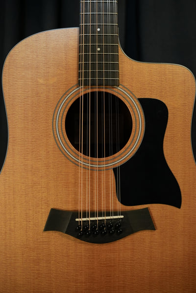 Close-up of the Taylor 150ce’s dreadnought body showing the torrefied spruce top and layered sapele sides, highlighting premium construction and finish.