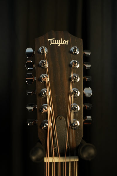 Close view of the Taylor 150ce headstock, mini die-cast tuners, and branding – built for precise tuning and reliability nationwide.