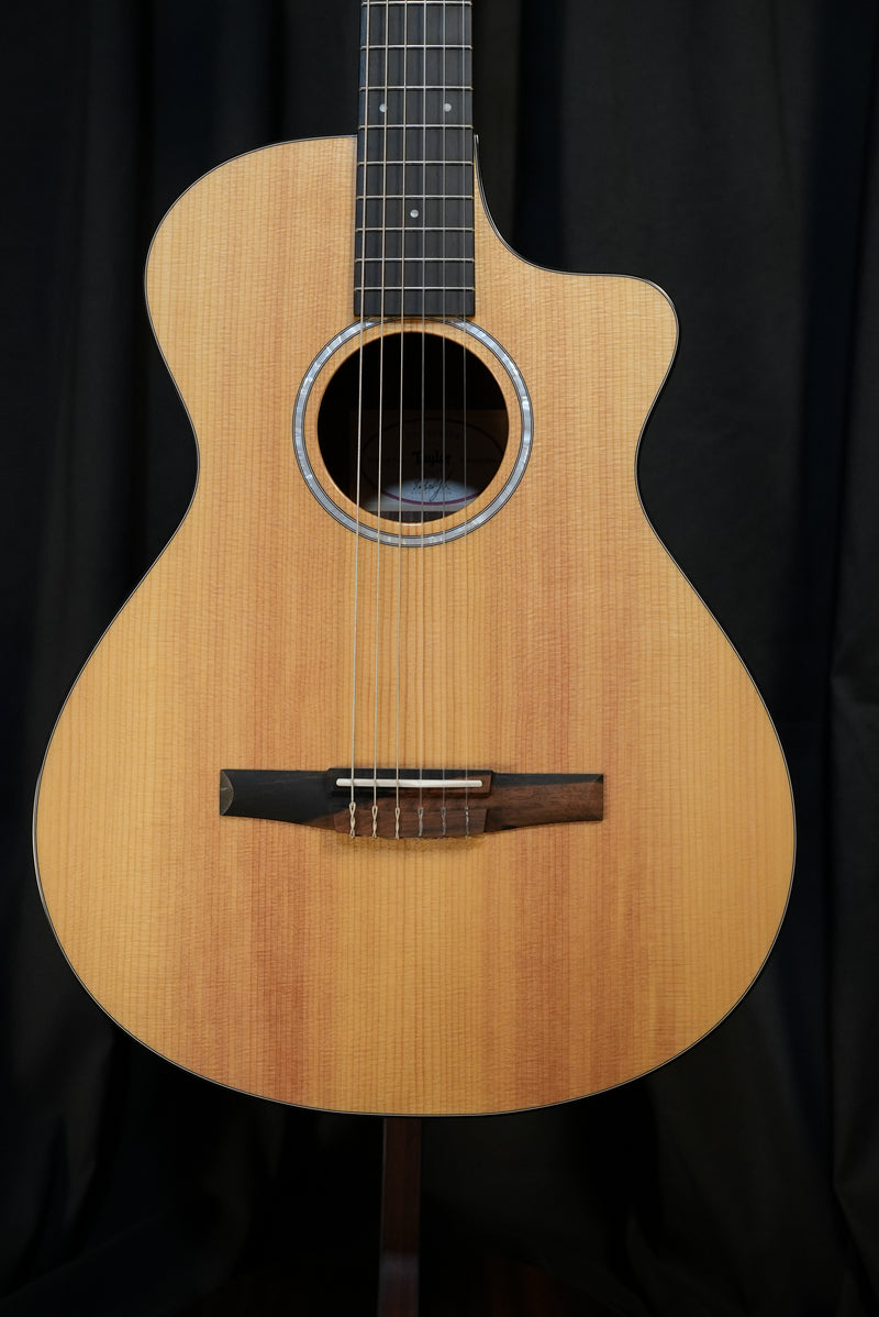 Full front view of the Taylor 212ce-N Plus showing solid torrefied spruce top and Grand Concert cutaway design.