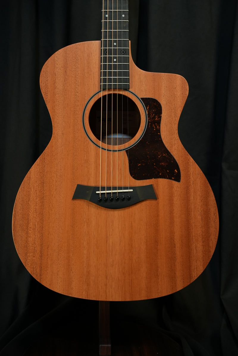 Full front view of the Taylor 24ce showing solid mahogany top and Grand Auditorium body.