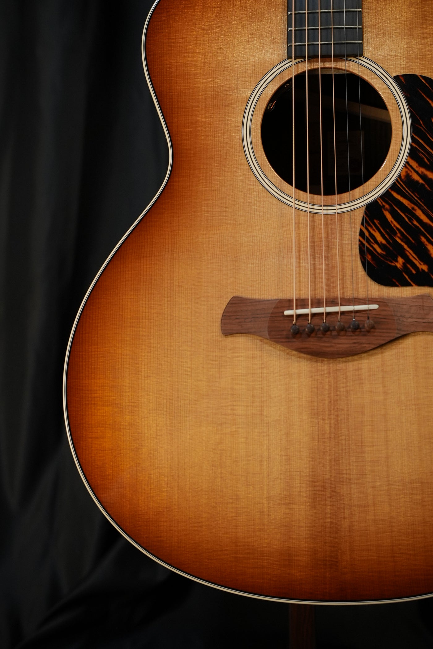 Taylor Gold Label 714e Sunburst torrefied Sitka spruce top Firestripe pickguard detail acoustic-electric guitar USA